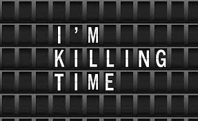 Board reading "I'm killing time"