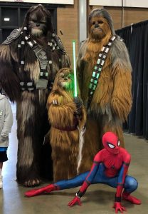 Two adult Wookie cosplayers, one child Wookie cosplayer, and a traditional Spider-Man cosplayer from Washington State Summer Con