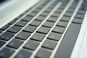 Laptop keyboard at a low angle, depicting four rows of keys and spacebar